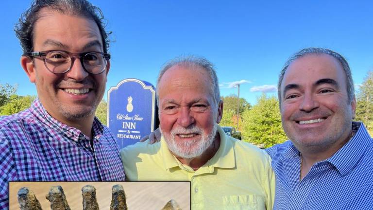 Alejandro and Joe Jr. flank their dad Joe Santandrea. The three men found an interesting artifact while out metal detecting.