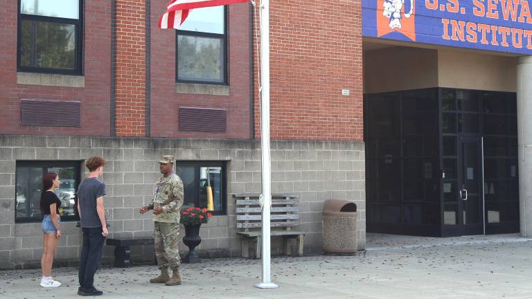 JROTC instructor Michael Washington with two JROTC cadets as S.S. Seward Institute.