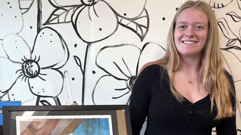 Warwick Valley High School sophomore Allie Wolf with her artwork.
