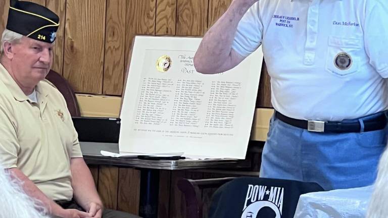 World War II Veteran Don McFarland salutes the POW-MIA Flag during a prior Warwick Flag Day service.