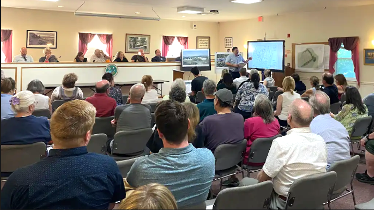 Crowd listens to an overview of proposed Blain Town Square project at the June 3 public scoping session.